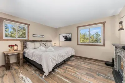 a bedroom with a bed and a fireplace at New The Pine Getaway Lots of Room Hot Tub Views in Pine