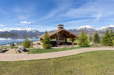 a gazebo with a lake and snow covered mountains at Lake Cliffe 305 Building A in Dillon