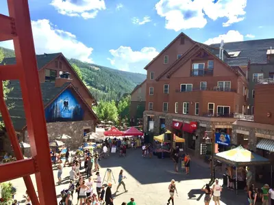 a group of people walking around a market in a town at Expedition Station 8635 by SummitCove Lodging in Keystone