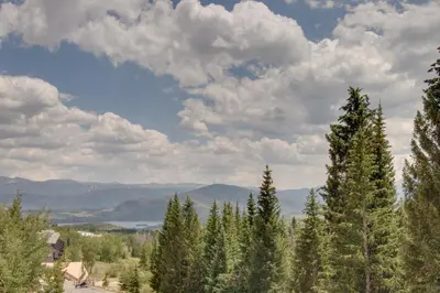 a group of trees on a hill with a cloudy sky at Buffalo Ridge C101 in Silverthorne