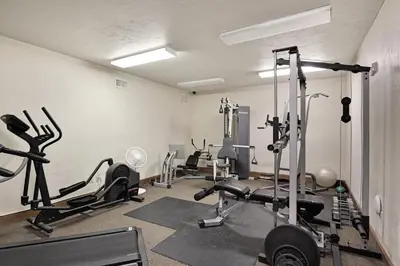 a gym with several tread machines in a room at Oro Grande 416 in Keystone