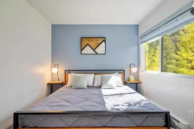 a bedroom with a bed with blue walls and a window at 1928 Soda Ridge in Keystone