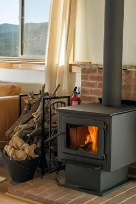 a fireplace in a living room with a fire at Skyline Lodge in Idaho Springs