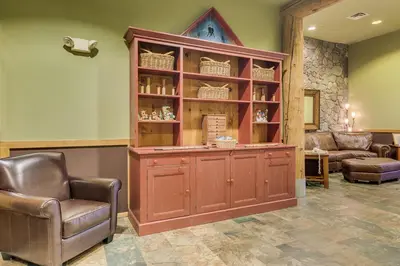 a large wooden cabinet in a room with two chairs at Arapahoe Lodge 8137 in Keystone
