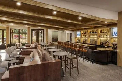 a restaurant with tables and chairs and a bar at Kindred Resort Luxury Ski In, Ski Out 2 Bedroom Residence At The River Run Gondola in Dillon