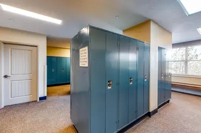 a locker room with blue lockers and a door at Base Camp One 314 in Granby