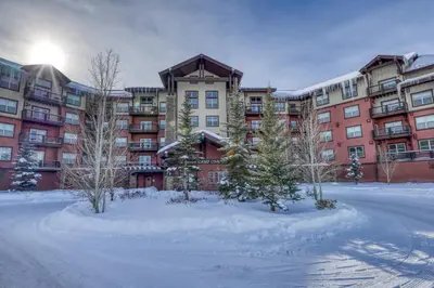 a large apartment building with snow in front of it at Base Camp One 403 in Granby