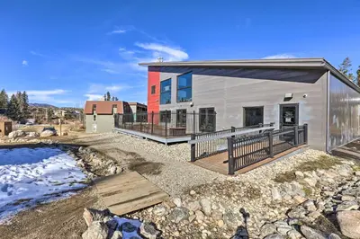 a modular home with a deck and a yard at 3BR Riverfront Retreat! Mtn Views, Community Perks in Winter Park