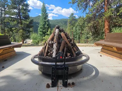 a pile of logsigunigunigunigunigunigunigunigun at Cabin 4- One Bedroom cabin- RMNP in Estes Park