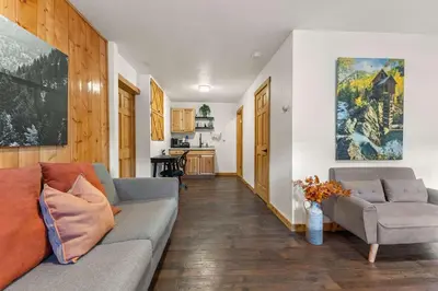 a living room with a couch and a table at Cabin 10- King Cabin Mins to RMNP in Estes Park