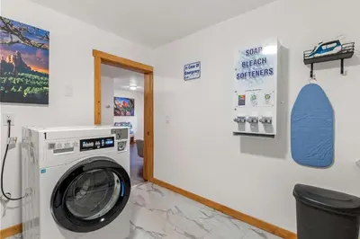 a laundry room with a washing machine in a room at Cabin 14 - King Bed hotel-style unit in Estes Park