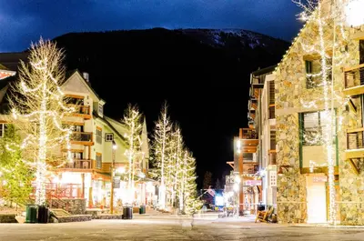 a town decorated with christmas lights at night at Lakeshore 1 in Keystone