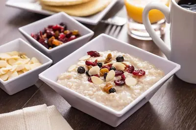 a bowl of oatmeal with fruit and nuts on a table at Hyatt Place Denver Tech Center in Centennial