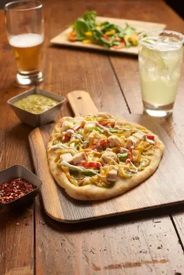 a pizza sitting on top of a wooden table at Hyatt Place Denver Tech Center in Centennial