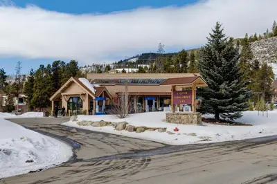 a building in the snow next to a street at Tennis Townhome Unit 1321 in Keystone