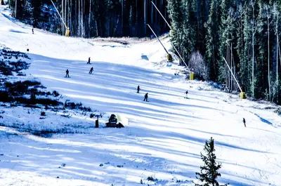 a group of people skiing down a snow covered slope at Tennis Townhome Unit 1321 in Keystone
