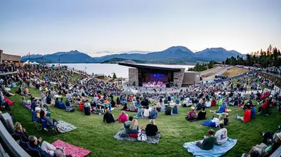 a large crowd of people sitting on the grass in front of a concert at Tennis Townhome Unit 1321 in Keystone