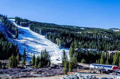 a snow covered mountain with a ski resort and a train at Snowdance 204A in Keystone