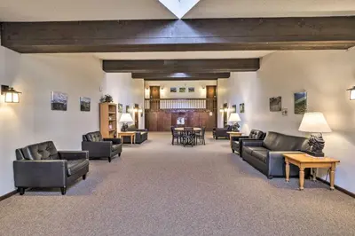 a large living room with couches and tables at Woodsy Winter Park Condo with Pool and Hot Tub Access in Winter Park