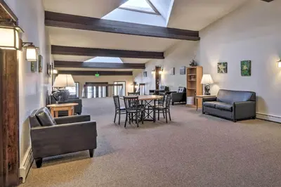 a living room with couches and a table and chairs at 3 Mi to Skiing Walkable Dtwn Winter Park Condo! in Winter Park