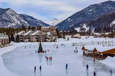 a group of people skiing on a ski slope in the snow at Wild Irishman 1029 - Keystone in Dillon