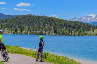 two people riding bikes on a path near a lake at Wild Irishman 1029 - Keystone in Dillon