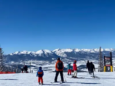 a group of people skiing on a ski slope at Lakeshore 1535 in Keystone