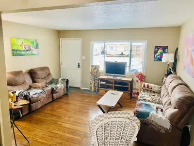 a living room with a couch and a tv at Master Bedroom and Bath in Arvada