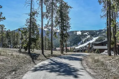 a road with trees on the side of a mountain at Gateway Lodge 5008 by SummitCove Lodging in Keystone