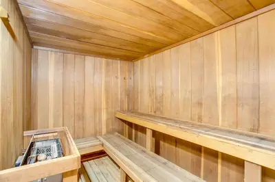 an empty wooden sauna with a bench in it at Heated Pool and Hot Tubs at Dtwn Winter Park Condo! in Winter Park