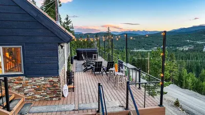 a deck with chairs and tables on top of a house at Skyline Lodge with Private Sauna & Hot Tub in Idaho Springs