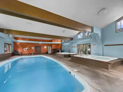 a large swimming pool in a building with a bath tub at A308 Lake Cliffe Condo in Dillon