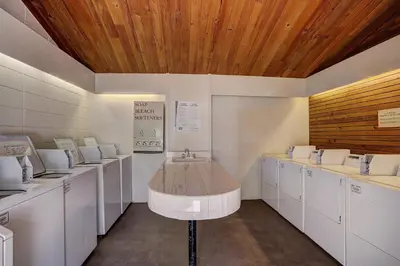 a room with white washing machines and a wooden ceiling at 2062 The Pines Condo in Keystone