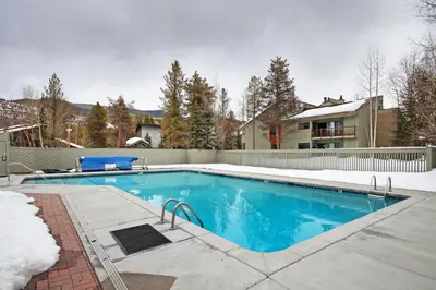 a swimming pool in a yard with a house at 1125 Flying Dutchman Condo in Keystone