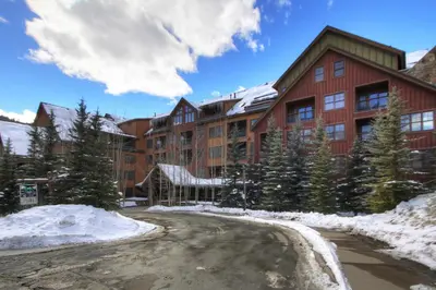 a large building with snow in front of it at 8824 The Springs Condo in Keystone