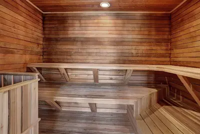 an empty sauna with wooden walls and wooden floors at 2130 Pines Condo in Keystone