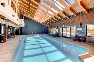a large swimming pool in a building with a ceiling at Mountainside 673 Home in Frisco