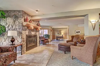 a living room with a large stone fireplace at 2640 Tenderfoot Lodge Condo in Keystone