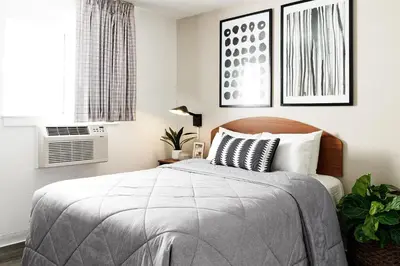 a bedroom with a bed and a window at InTown Suites Extended Stay Denver - Havana Street in Aurora