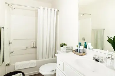 a white bathroom with a toilet and a sink at InTown Suites Extended Stay Denver - Havana Street in Aurora