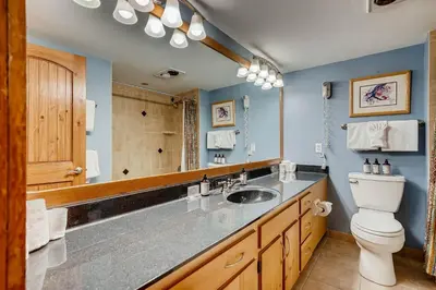 a bathroom with a sink and a toilet and a mirror at Decatur 1779 in Keystone
