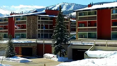 a building with a christmas tree in the snow at Silverado II in Winter Park