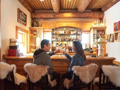 a man and a woman sitting at a bar at Lenawee 1735 in Keystone