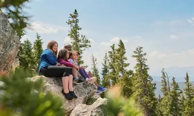 a group of people sitting on top of a rock at Argentine 1525 in Keystone
