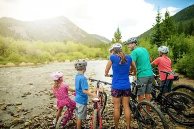 a group of people with bikes on a river at Flying Dutchman 1124 in Keystone