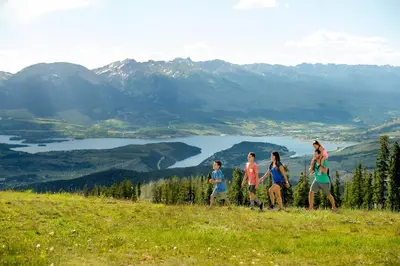 a group of people walking on top of a hill at Willows 1716 in Keystone