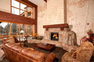 a living room with a couch and a fireplace at Springs 8848 in Keystone