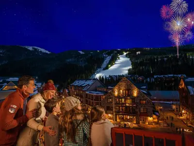 a group of people standing on top of a building with fireworks at Flying Dutchman 1210 in Keystone