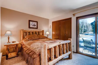 a bedroom with a bed and a sliding glass door at Flying Dutchman 1210 in Keystone