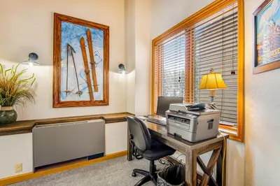 an office with a computer on a desk with a window at Iron Horse Studio in Winter Park